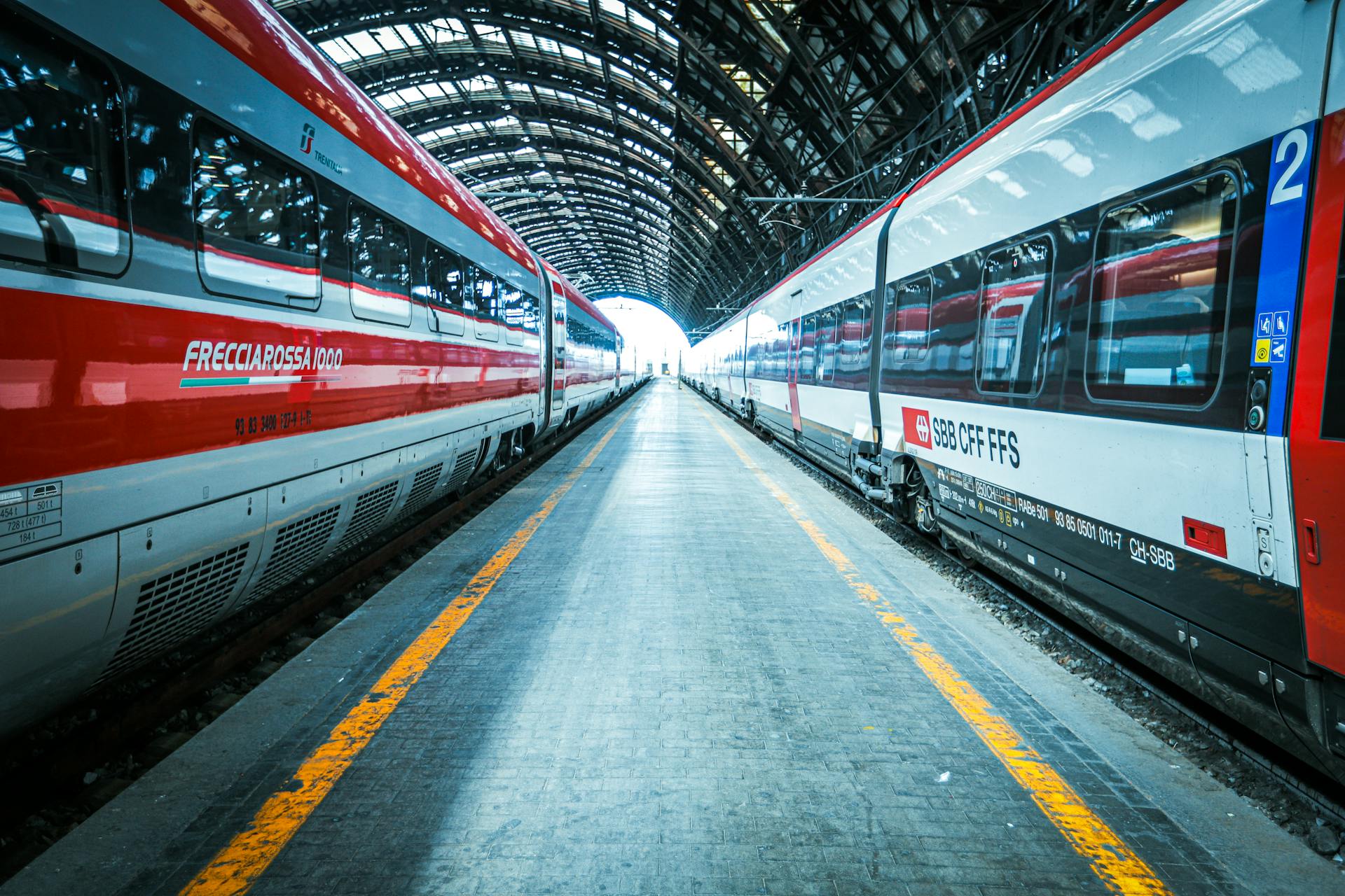 Red and White Trains in a Terminal Train Station in Milano