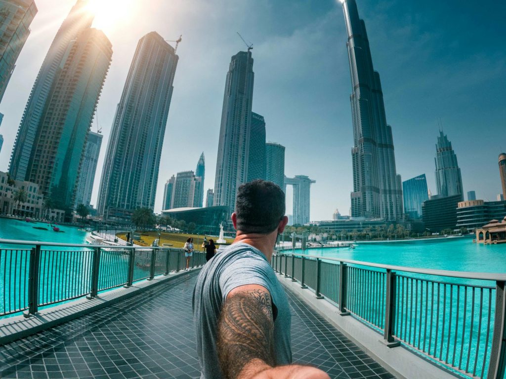 Man in Grey T-shirt Crossing a Foot Bridge in Dubai