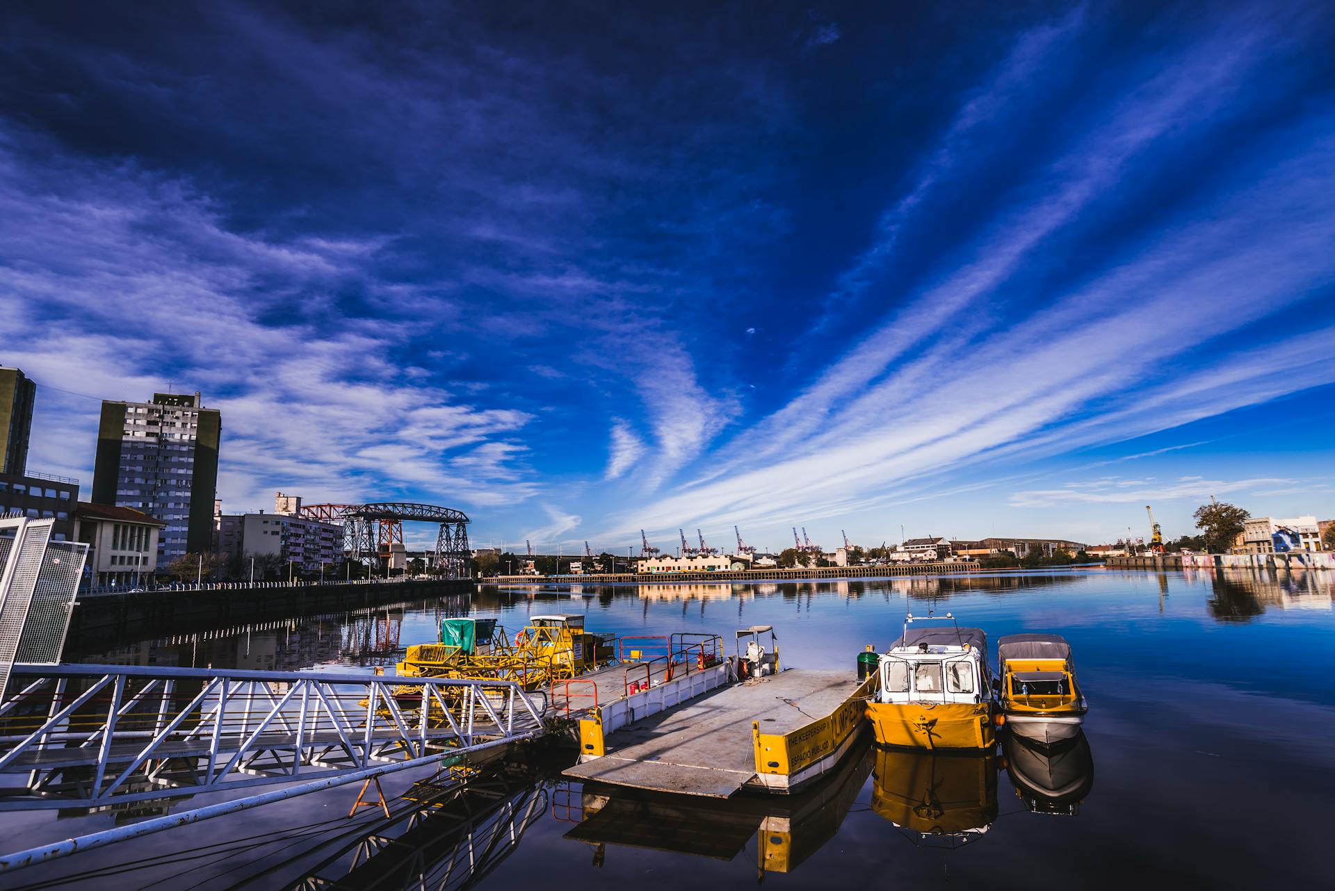 Colorful Waterfront with Boats and Dramatic Sky