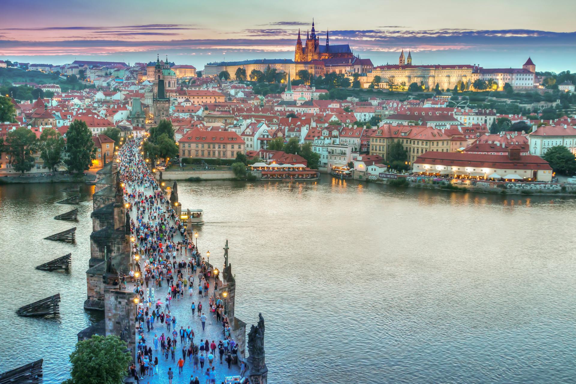People Walking on Concrete Bridge in Prague