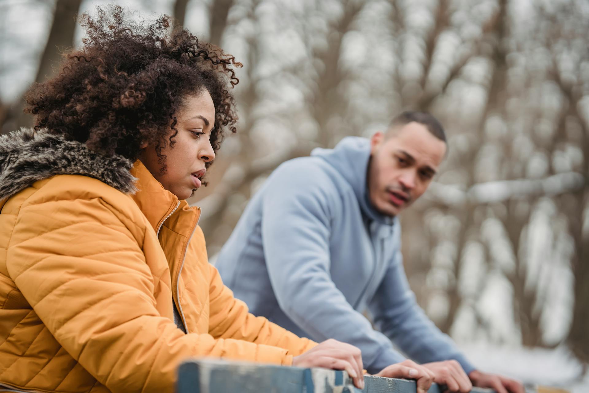 Black couple training on winter street