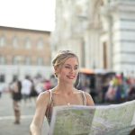 Woman Holding A Map Looking For Next Destination in Siena, Italy