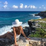 A Woman in White Hat Sitting on the Beach - Isla Mujeres, Q.R., Mexiko