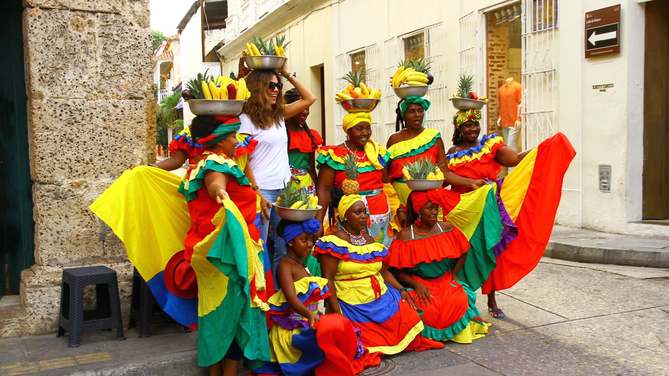 CARTAGENA, COLOMBIA - 15 May 2019. Palenqueras who are Afro-Colombian fruitseller women in Cartagena, are taking pictures with tourists on the streets. They are one of the symbols of the city.