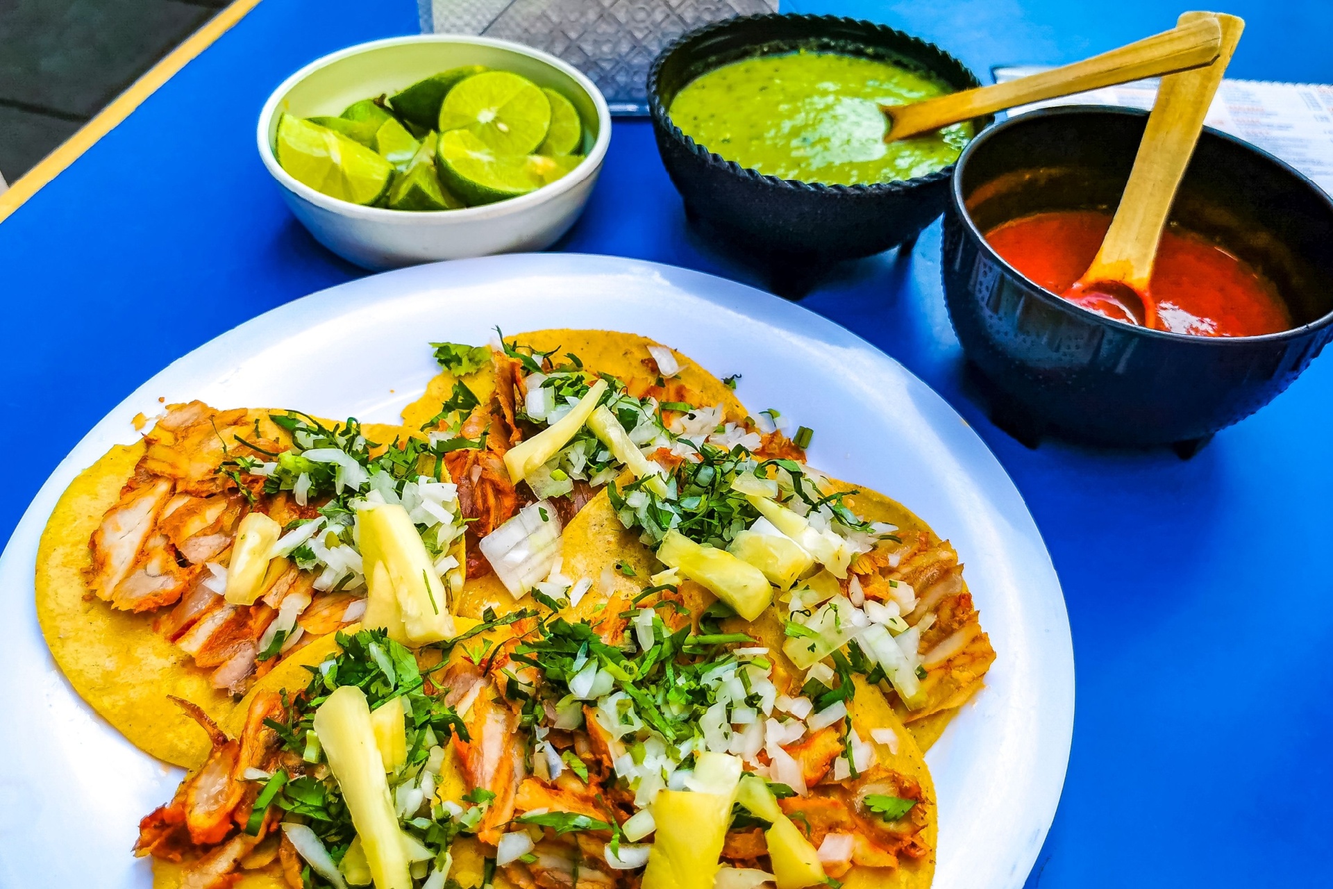 Mexican tacos with lime hot sauce pineapple and onions in Centro Historico Mexico City Mexico.