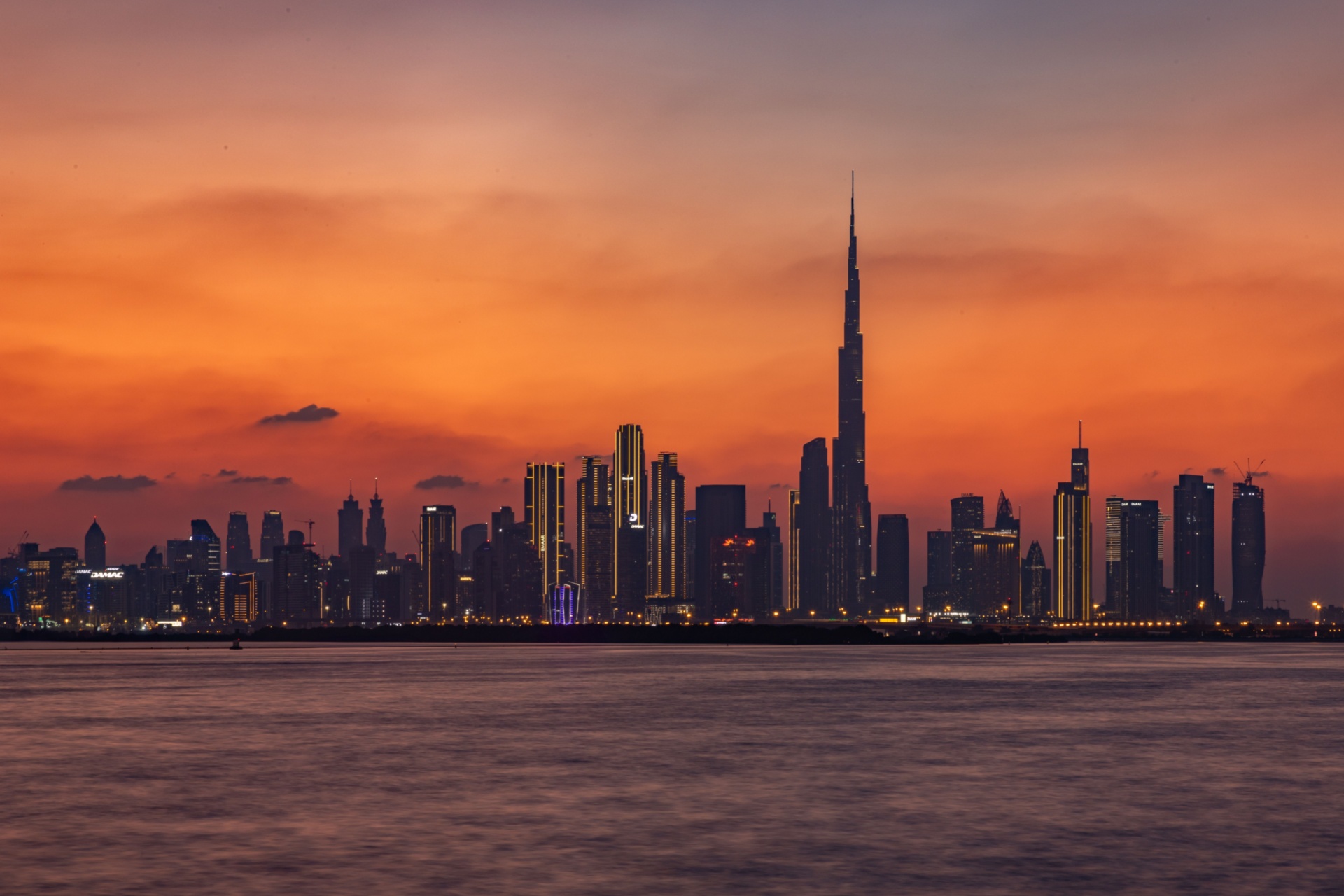 Dubai, United Arab Emirates - November 5th, 2023: A colorful picture of Downtown Dubai at sunset, with the Burj Khalifa towering the other high rises.