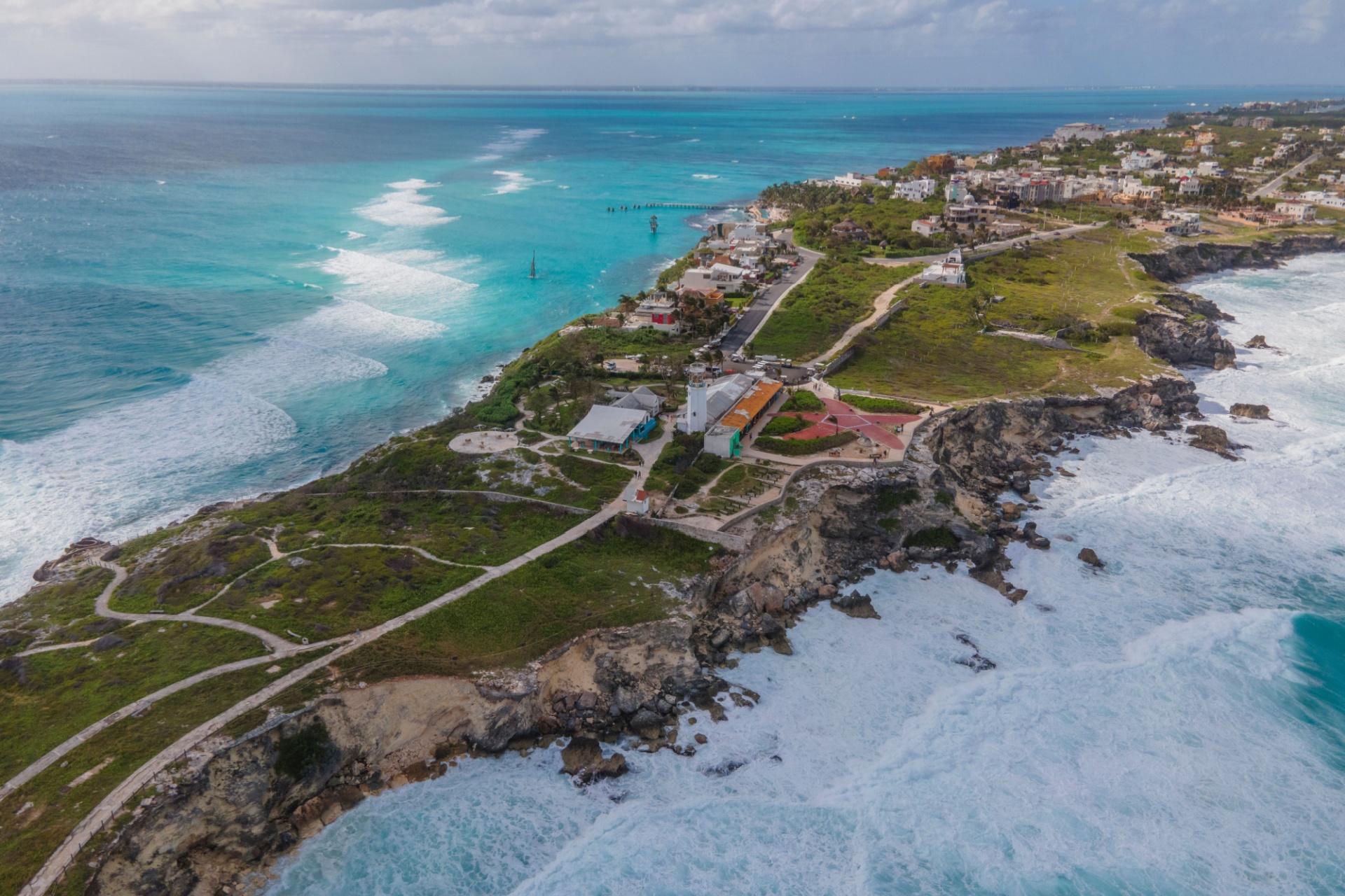 Aerial footage of Isla Mujeres highlights dramatic cliffs, turquoise seas, and tropical beauty along Mexico,s picturesque coastline.