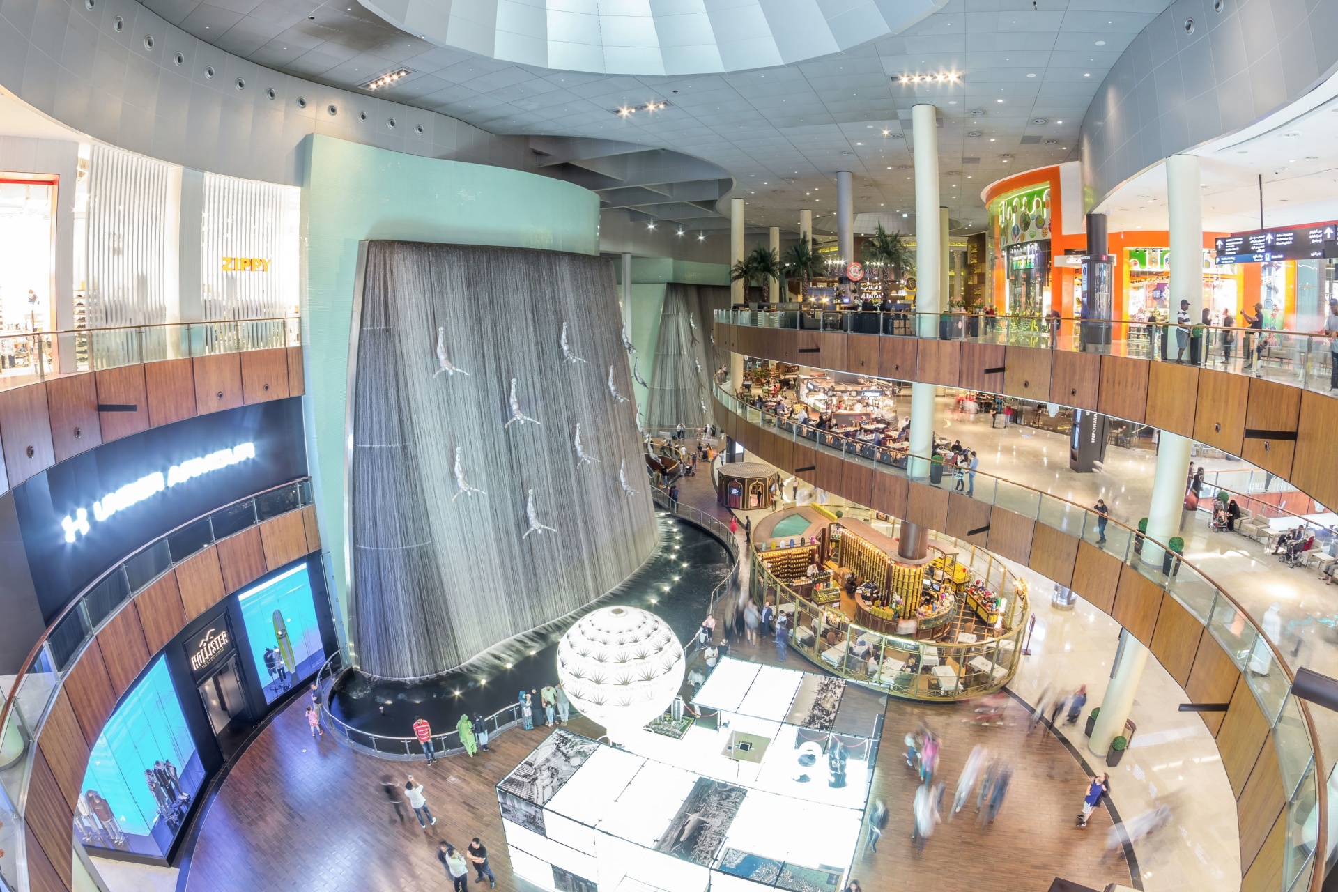 Dubai, UAE - Feb 8, 2023: Giant Fountain with Flying Sculpture of an Diver panoramic in Dubai Mall. The Fountain Dedicated to the Extraction of Pearls.