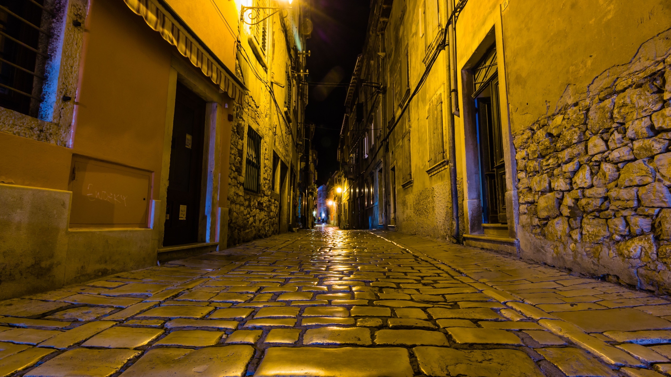 Narrow street in night of old town of Rovinj, Croatia