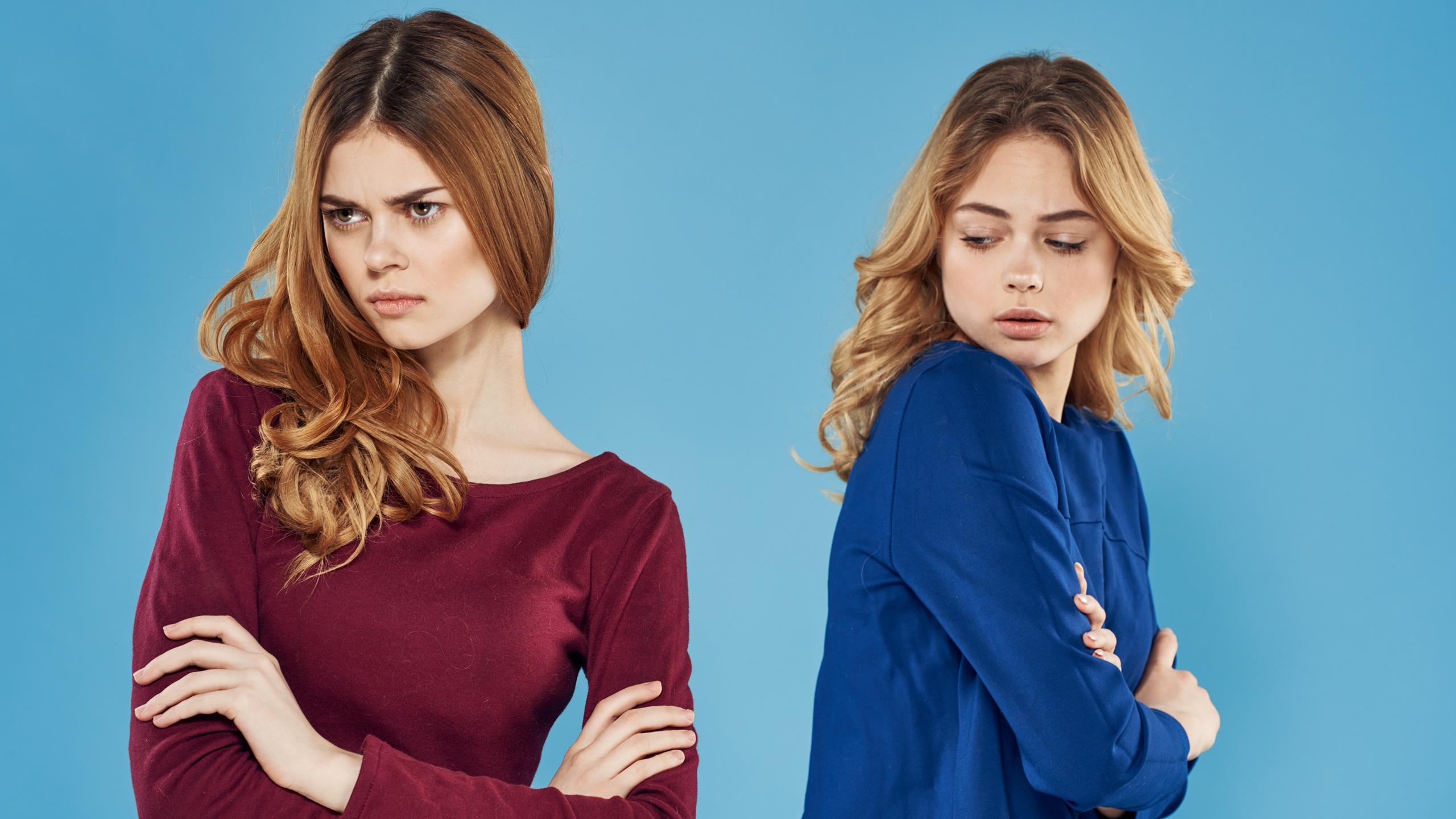 Quarreled girlfriends on a blue background