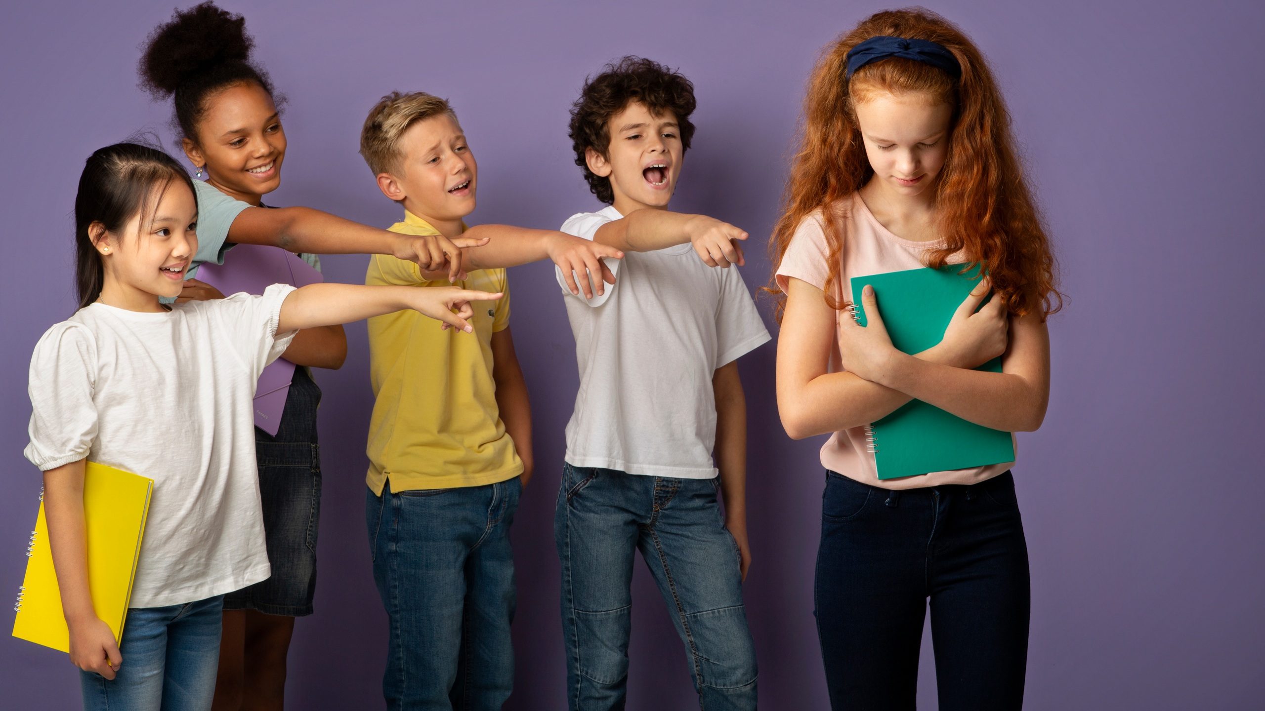 Group of mean schoolchildren bullying their upset red-haired classmate on violet background