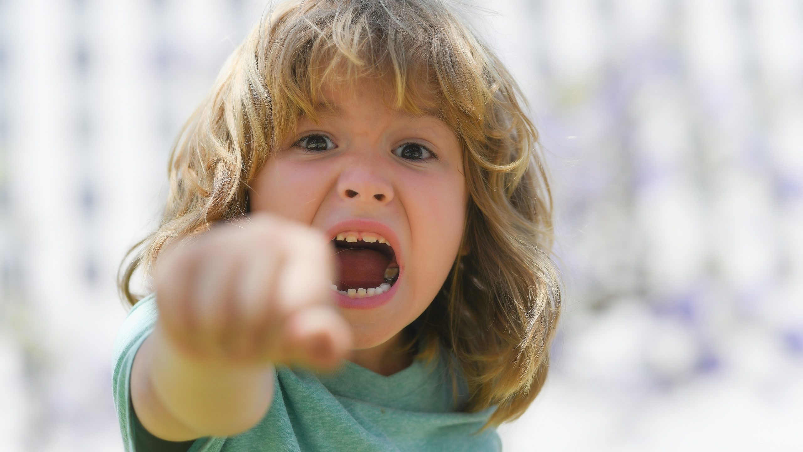 Boy fight with fist gesture punch. Kid boy with angry expression. Angry hateful little crazy boy, child furious. Angry rage kids face. Aggressive and mad kid angry behavior.