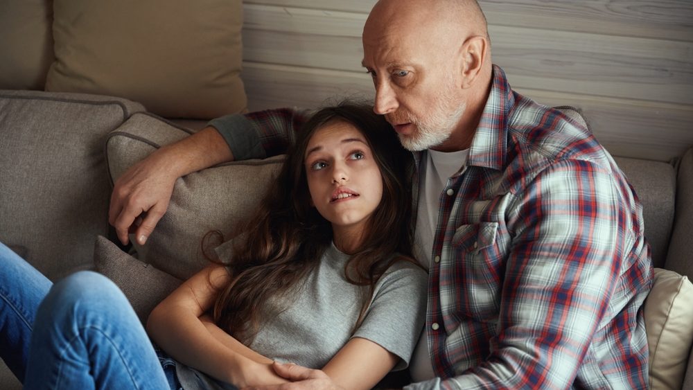 Worried daughter looking at her sad dad