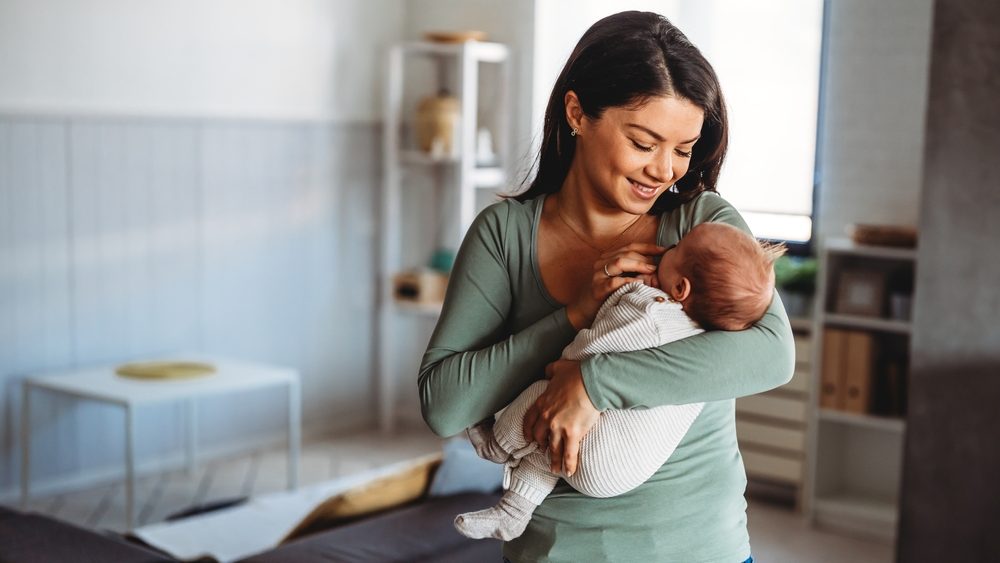 Family, motherhood, parenting, people baby and child care concept. Happy mother with adorable baby