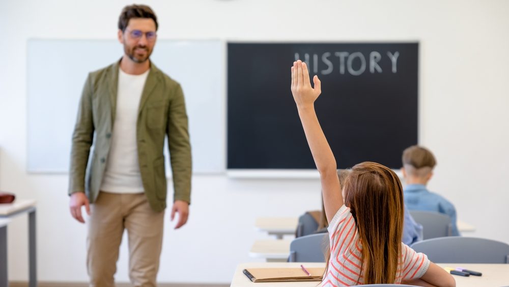 Male teacher and the kids at the history lesson
