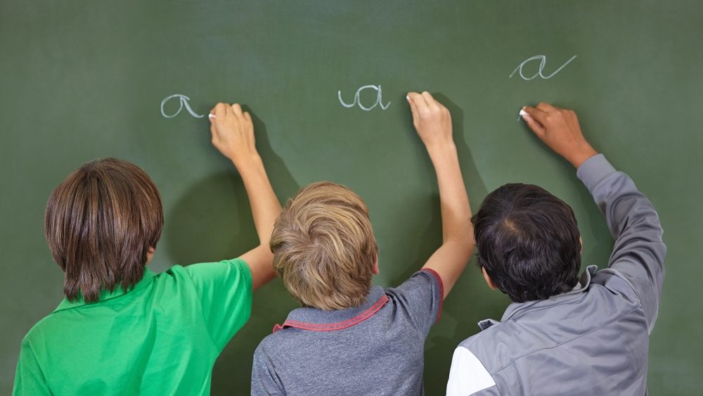 Children, chalkboard and school writing with education, cursive and answer for learning. Back, knowledge and youth development in a study lesson with students in classroom with chalk and solution