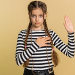 I swear to be honest. Sincere responsible preteen child girl kid raising hand to take oath, promising to be honest, to tell truth, keeping hand on chest, justice. Teenager children on beige background