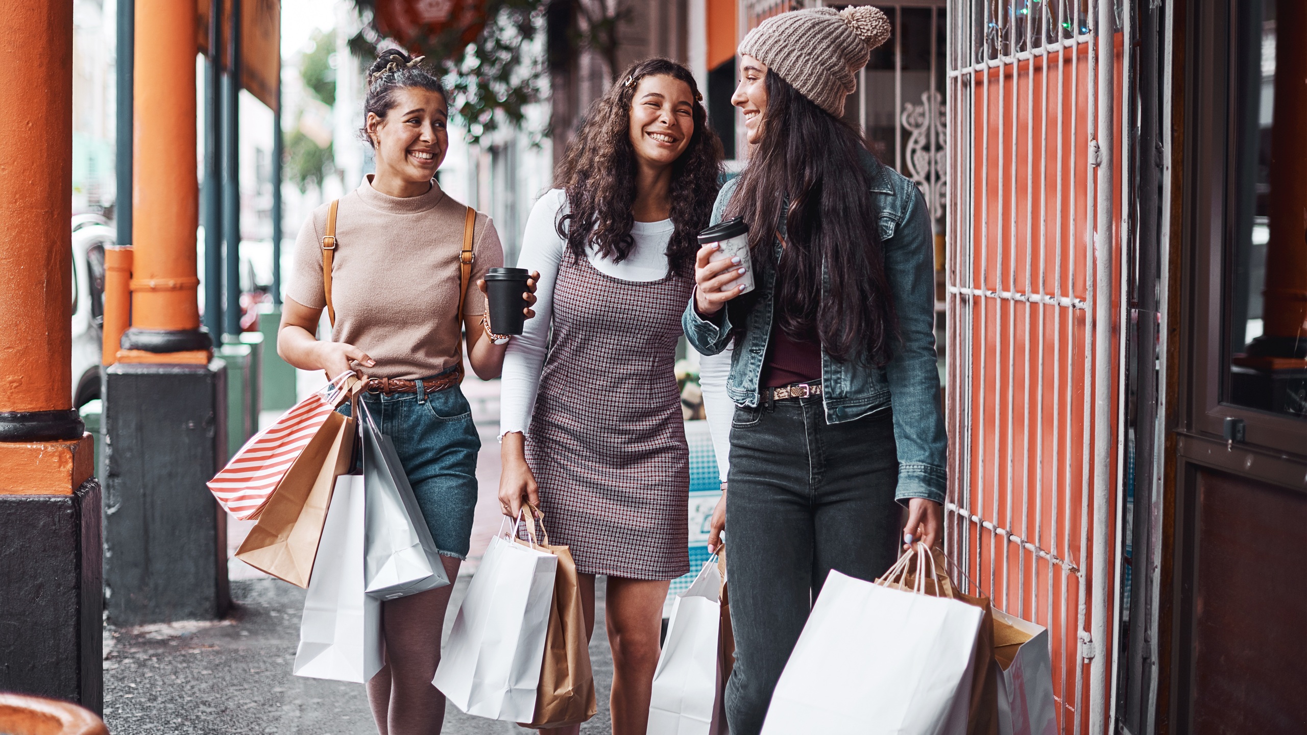 Women, friends and bags for shopping in city with bonding time, fashion discount and outdoor with retail purchase. Gen z people, urban street and girl siblings with boutique product, love and weekend
