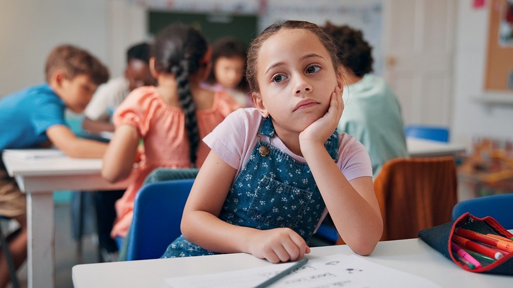 Bored, thinking and student with girl in classroom for education, learning disorder and future. Problem solving, mental health and reflection with child with adhd in school for studying and idea