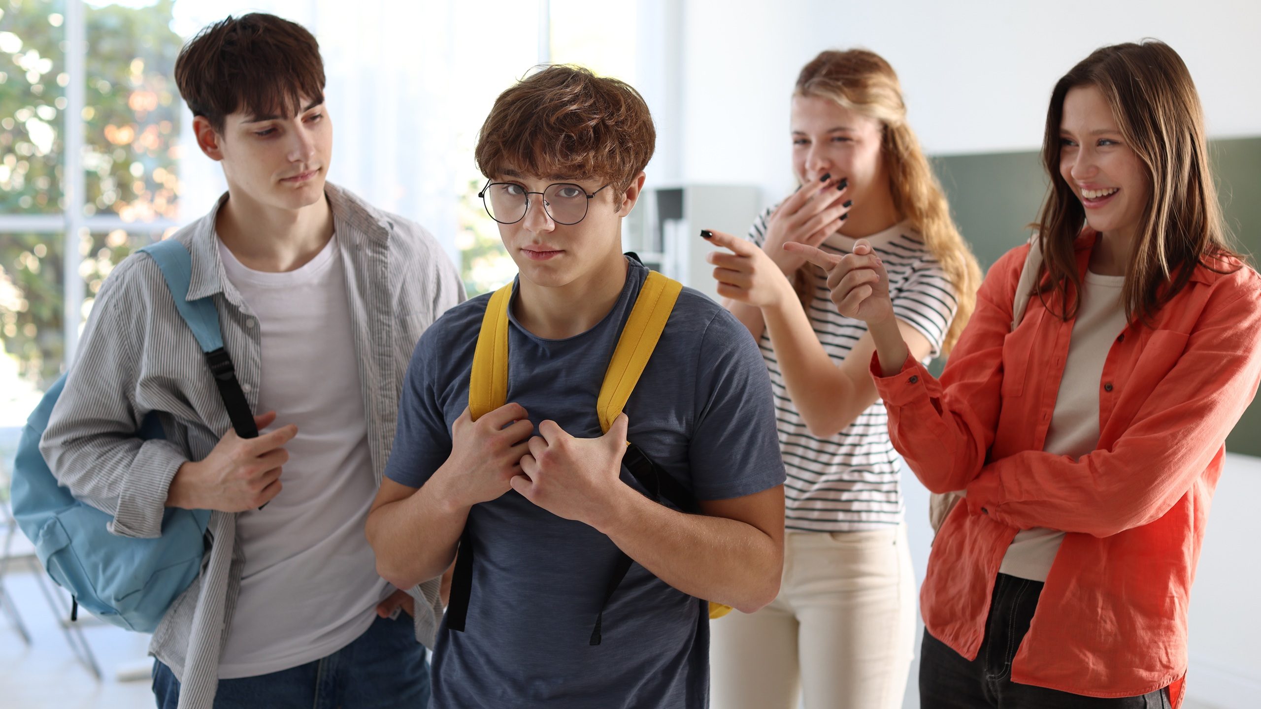 Group of students bullying their classmate in classroom