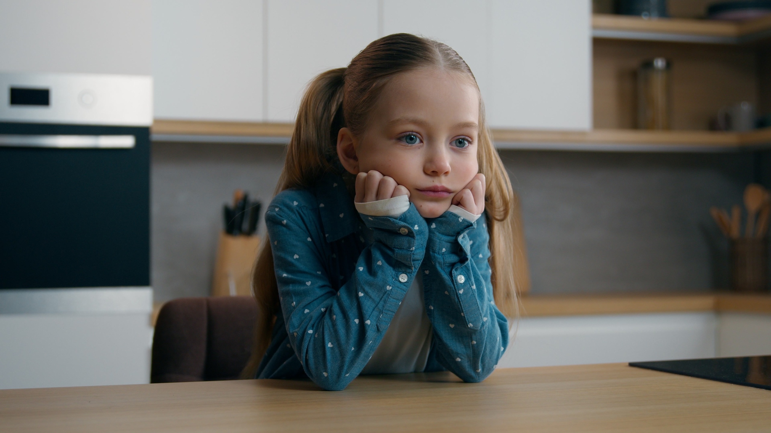 Frustrated grief worried little offended Caucasian sad upset bored child girl orphan unhappy bad relationship lonely kid at home kitchen alone stressed daughter sadness family quarrel thinking boring