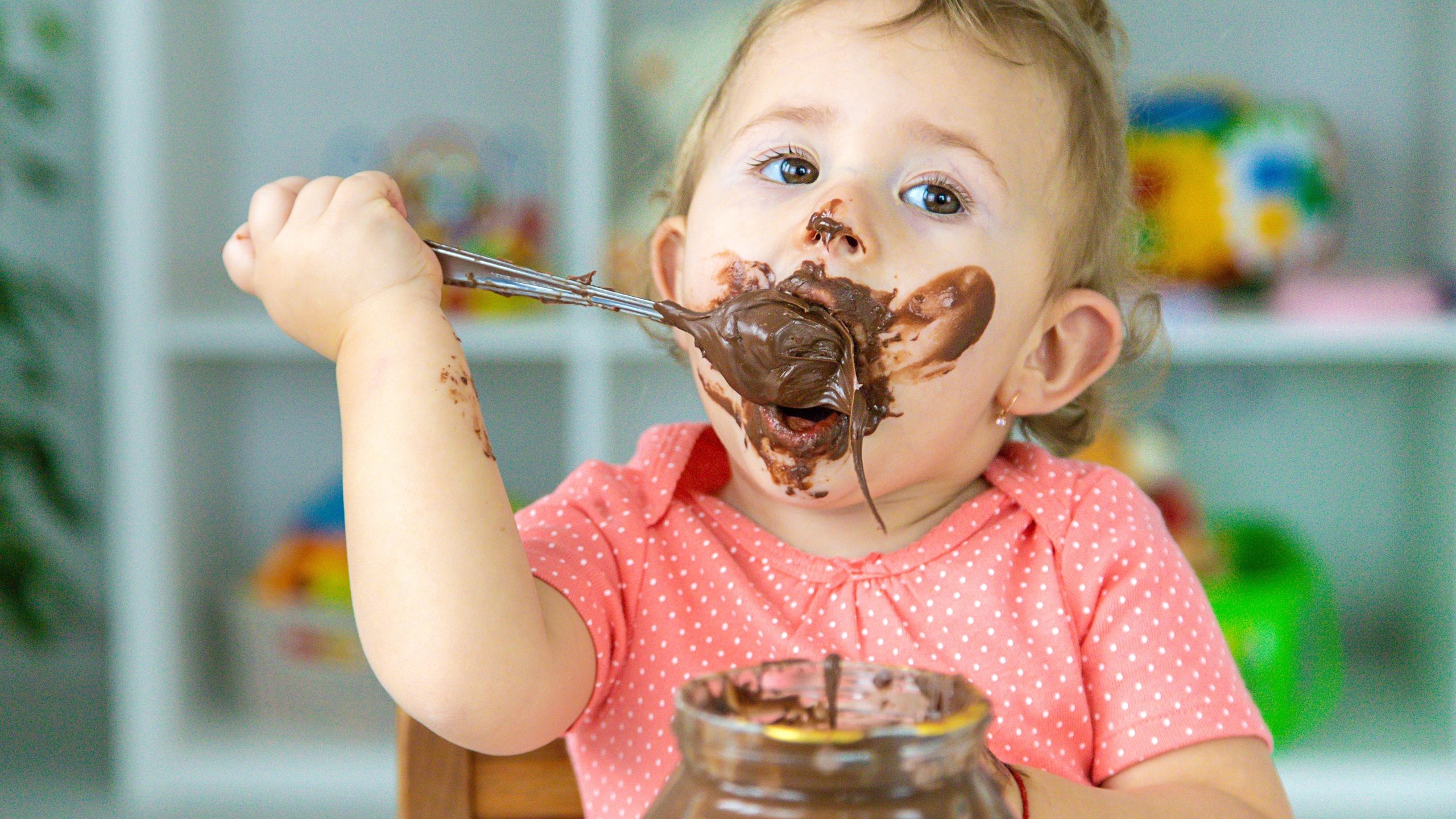Baby eats chocolate sweets a lot. Selective focus. Child.