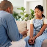 Childcare, dad or girl in house with scolding, behavior challenge or teaching for emotional growth. Upset, warning or family with lesson, conflict resolution or discipline issue in child development