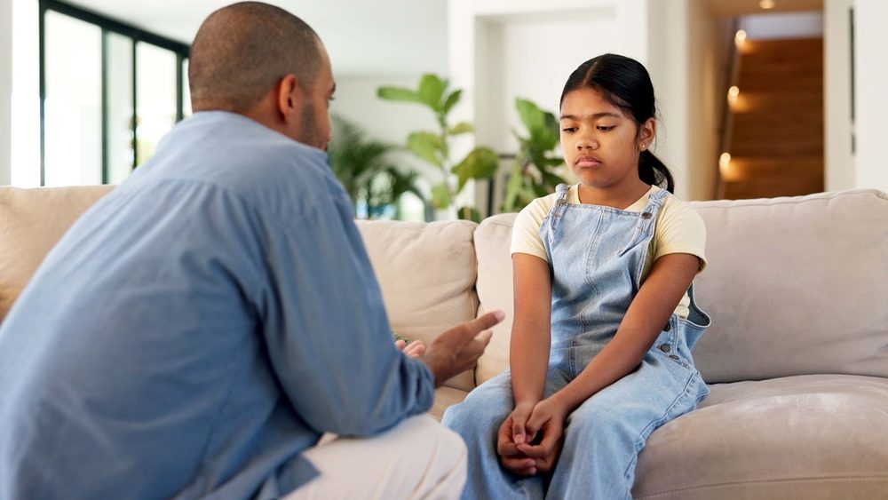 Childcare, dad or girl in house with scolding, behavior challenge or teaching for emotional growth. Upset, warning or family with lesson, conflict resolution or discipline issue in child development