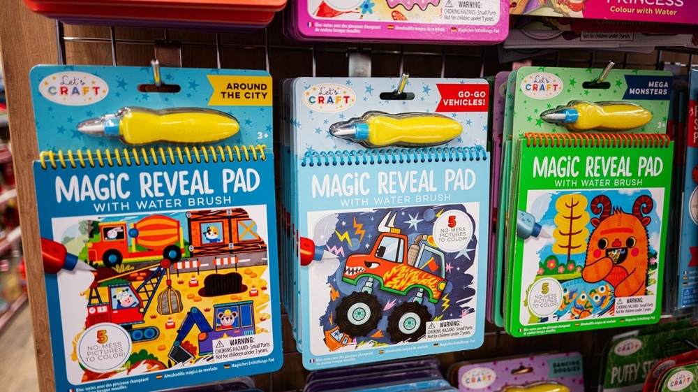 Lviv, Ukraine - March 19, 2025: A vibrant assortment of water reveal activity books displayed neatly on retail shelves.