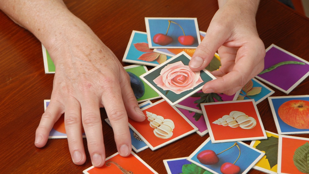TENERIFE, CANARY ISLANDS - MARCH 10, 2014: Woman playing with didactic cards