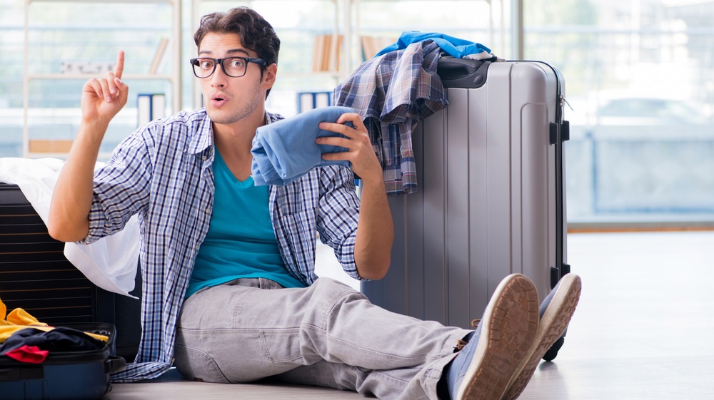 Young man preparing for vacation travel
