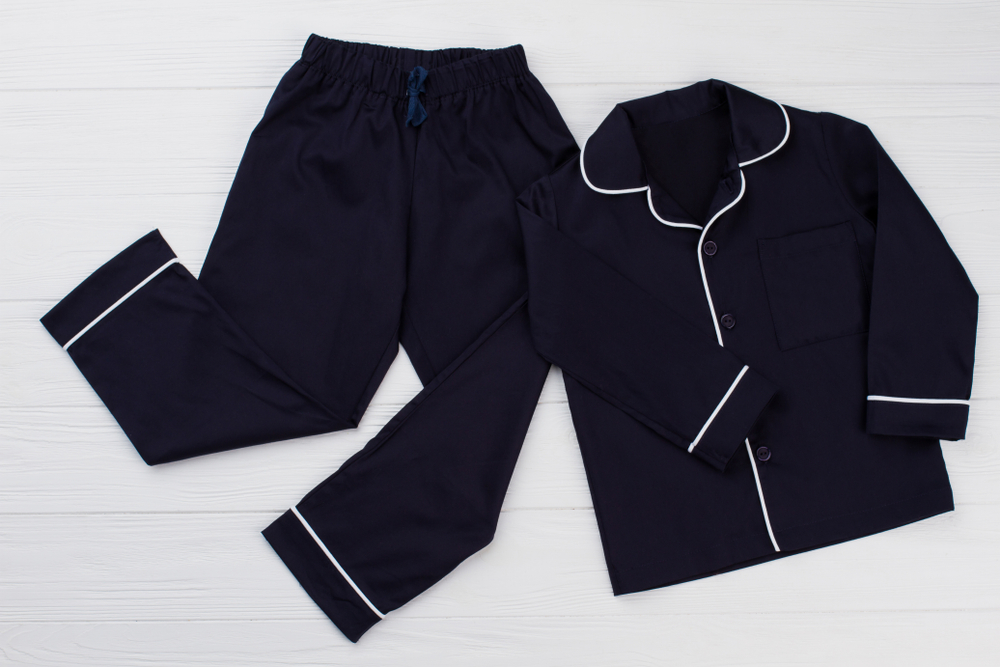 Classic pajama for young boy. Navy shirt and pants decorated with white edging. Simple and elegant.